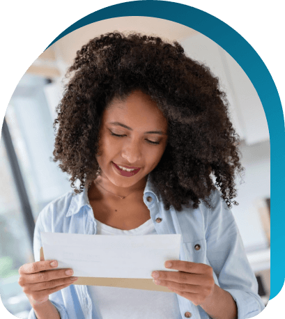 Woman looking at a personalized, targeted direct mail offer sent to her at home