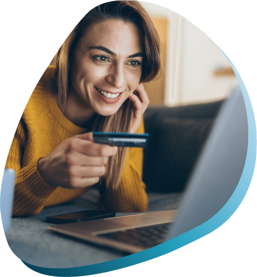 Smiling woman preparing to pay for an online purchase or make a donation on her latop holding her credit card