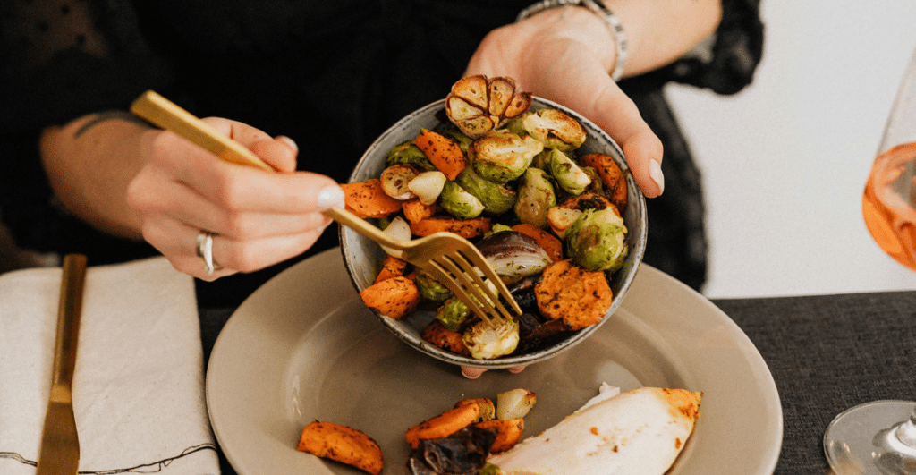 close up on someone eating a bowl of vegetables